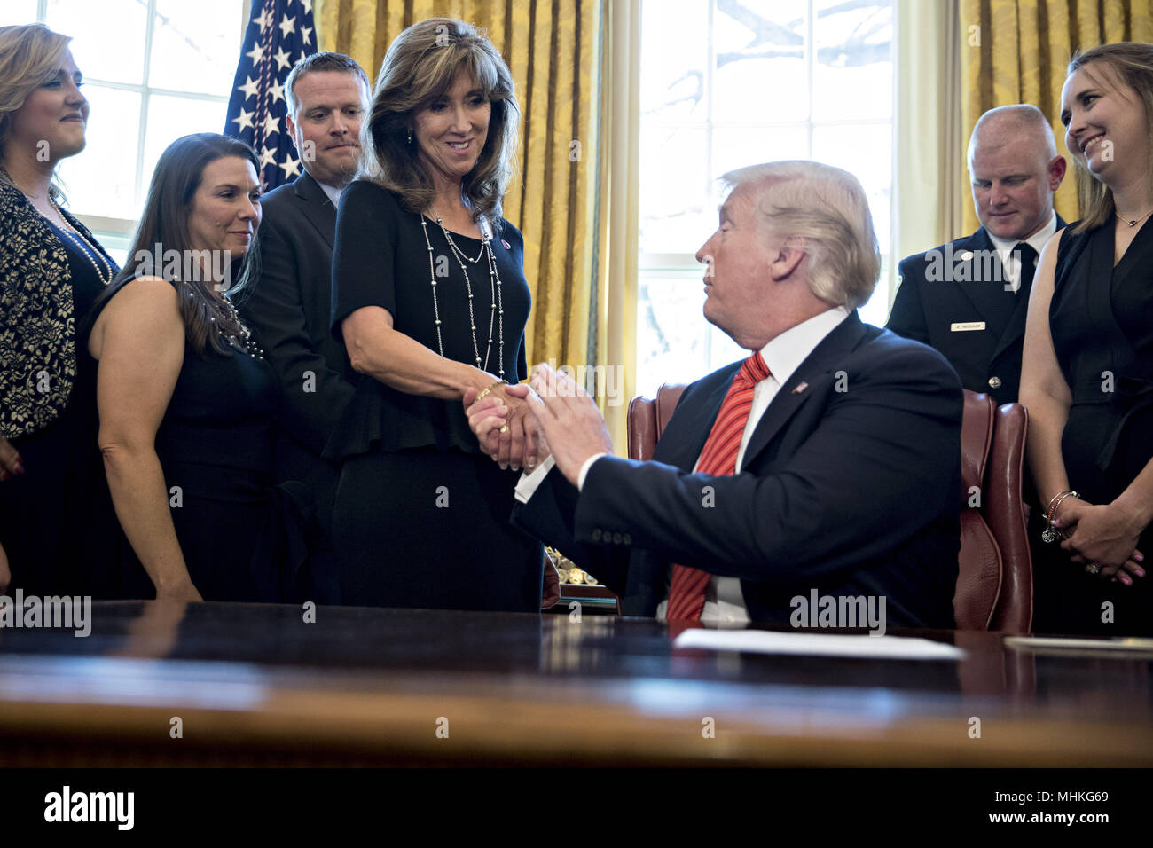 United States President Donald Trump, right, shakes hands with Tammie Jo Shults, a Southwest Airlines Co. captain, while meeting with the crew and passengers of Southwest Airlines flight 1380 in the Oval Office of the White House in Washington, DC, U.S., on Tuesday, May 1, 2018. An engine on Southwest's flight 1380, a Boeing Co. 737-700 bound for Dallas from New York's LaGuardia airport, exploded and made an emergency landing on April 17 sending shrapnel into the plane and killing a passenger seated near a window. Credit: Andrew Harrer/Pool via CNP | usage worldwide Stock Photo