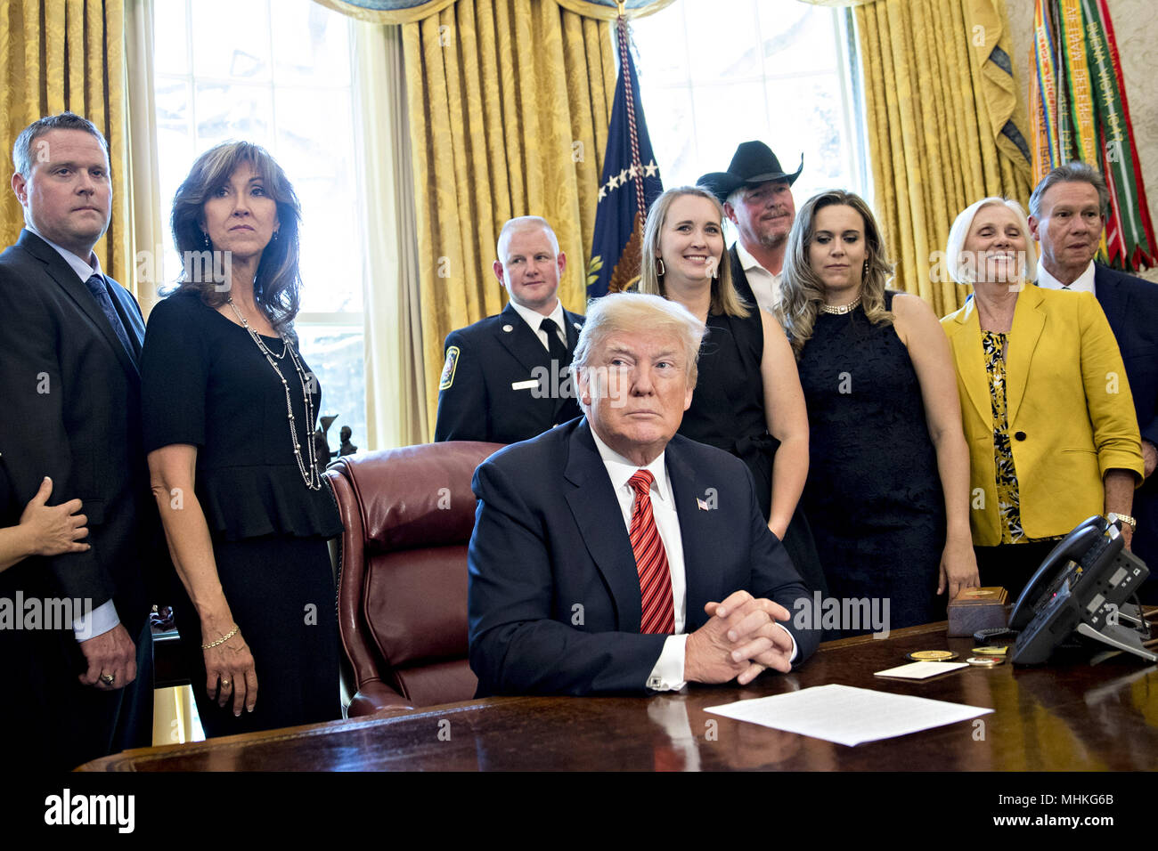 United States President Donald Trump, center, waits to speak next to Tammie Jo Shults, a Southwest Airlines Co. captain, second left, and Darren Ellisor, a Southwest Airlines first officer, left, while meeting with the crew and passengers of Southwest Airlines flight 1380 in the Oval Office of the White House in Washington, DC, U.S., on Tuesday, May 1, 2018. An engine on Southwest's flight 1380, a Boeing Co. 737-700 bound for Dallas from New York's LaGuardia airport, exploded and made an emergency landing on April 17 sending shrapnel into the plane and killing a passenger seated near a windo Stock Photo