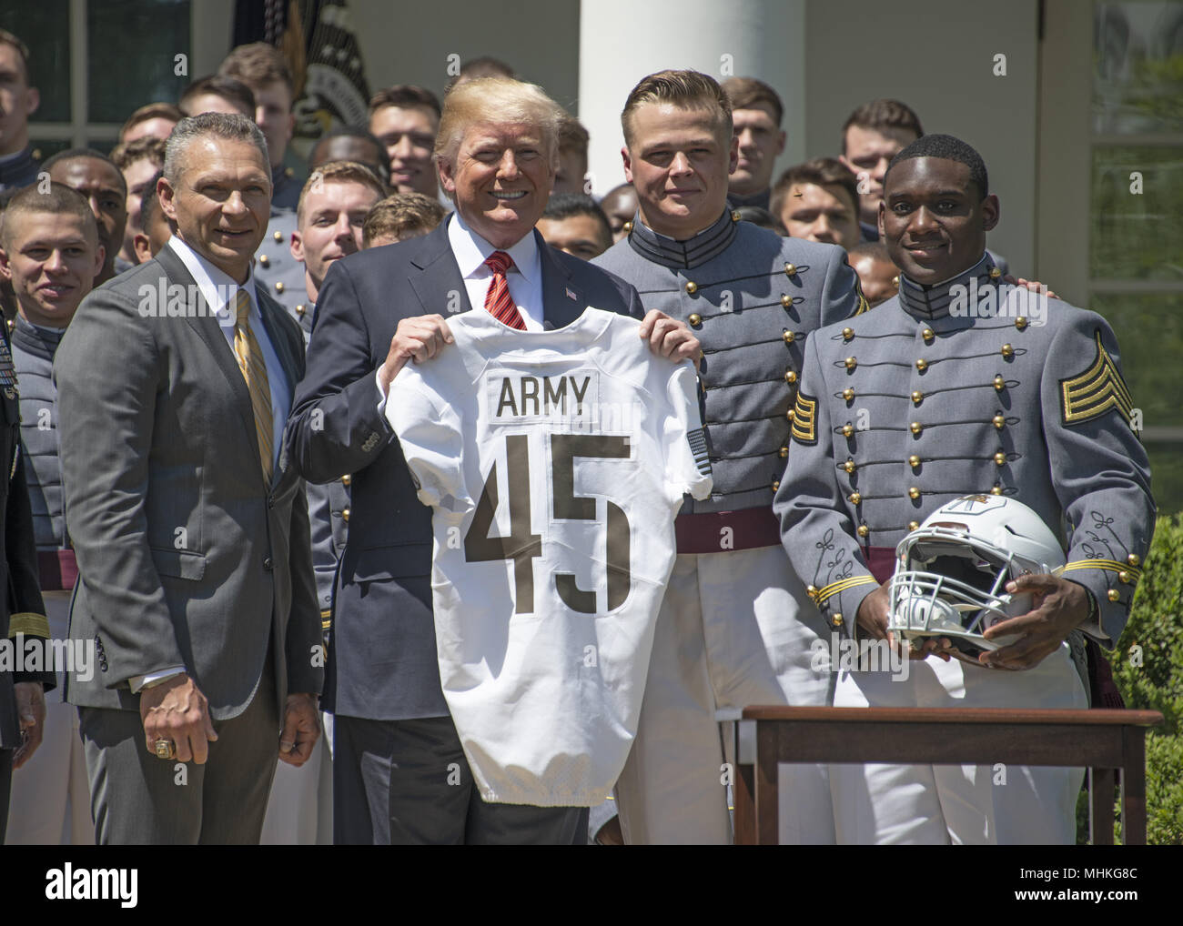 United States President Donald J. Trump presents the Commander-in-Chief's Trophy to the U.S. Military Academy football team in the Rose Garden of the White House in Washington, DC on Tuesday, May 1, 2018. The Commander-in-Chief's trophy is presented to the winner of the annual Army-Navy football game which was played at Lincoln Financial Field in Philadelphia, Pennsylvania on December 9, 2017. Pictured from left to right: Head coach Jeff Monken, President Trump, defensive lineman and co-Captain John Voit (59), and quarterback and co-Captain Ahmad Bradshaw (17). The Army Black Knights beat the Stock Photo