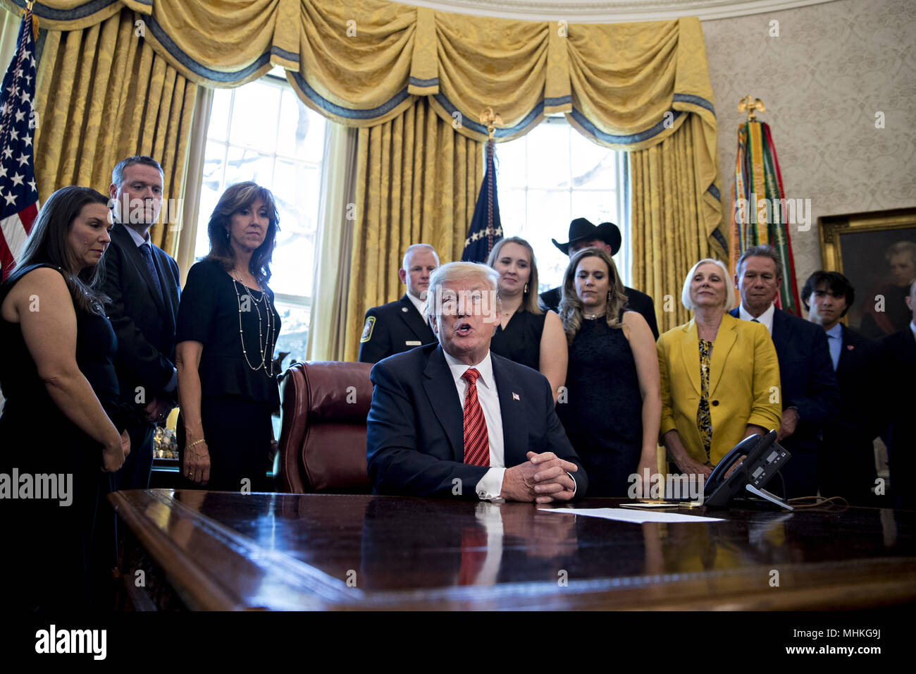 United States President Donald Trump, center, speaks as Tammie Jo Shults, a Southwest Airlines Co. captain, third left, and Darren Ellisor, a Southwest Airlines first officer, second left, listen while meeting with the crew and passengers of Southwest Airlines flight 1380 in the Oval Office of the White House in Washington, DC, U.S., on Tuesday, May 1, 2018. An engine on Southwest's flight 1380, a Boeing Co. 737-700 bound for Dallas from New York's LaGuardia airport, exploded and made an emergency landing on April 17 sending shrapnel into the plane and killing a passenger seated near a windo Stock Photo