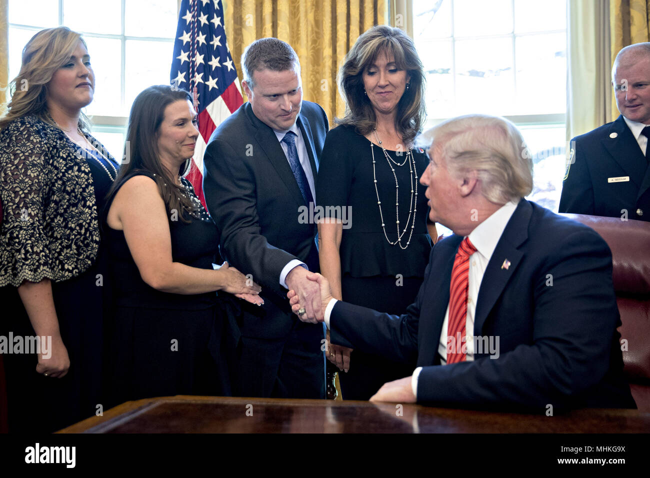 United States President Donald Trump, right, shakes hands with Darren Ellisor, a Southwest Airlines Co. first officer, next to Tammie Jo Shults, a Southwest Airlines captain, center, while meeting with the crew and passengers of Southwest Airlines flight 1380 in the Oval Office of the White House in Washington, DC, U.S., on Tuesday, May 1, 2018. An engine on Southwest's flight 1380, a Boeing Co. 737-700 bound for Dallas from New York's LaGuardia airport, exploded and made an emergency landing on April 17 sending shrapnel into the plane and killing a passenger seated near a window. Credit: A Stock Photo