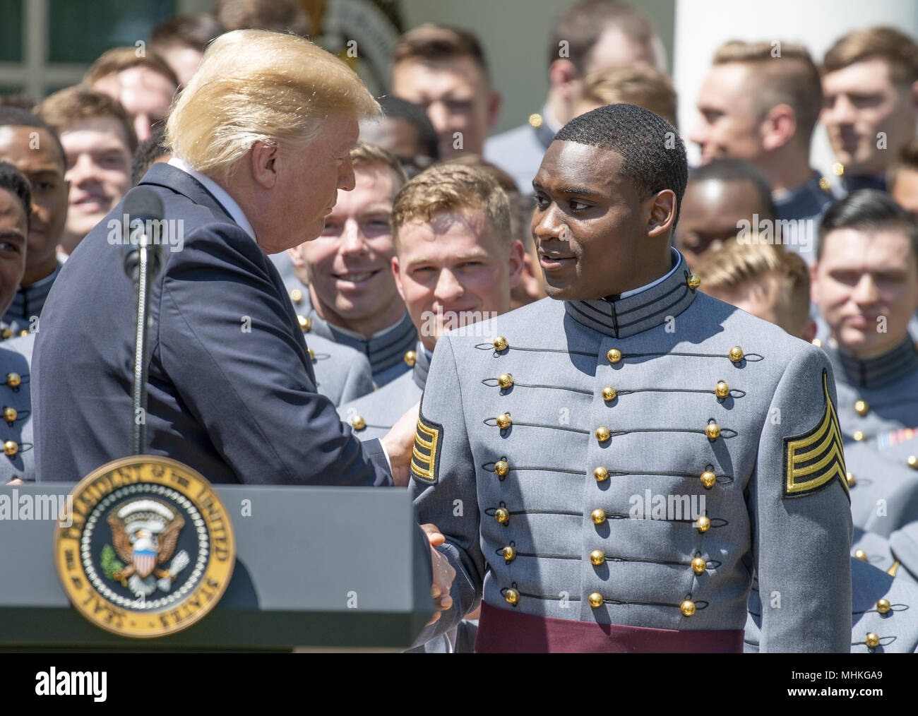 United States President Donald J. Trump recognizes quarterback and co-Captain Ahmad Bradshaw (17) as he presents the Commander-in-Chief's Trophy to the U.S. Military Academy football team in the Rose Garden of the White House in Washington, DC on Tuesday, May 1, 2018. The Commander-in-Chief's trophy is presented to the winner of the annual Army-Navy football game which was played at Lincoln Financial Field in Philadelphia, Pennsylvania on December 9, 2017. The Army Black Knights beat the Navy Midshipmen 14 - 13. Credit: Ron Sachs/CNP | usage worldwide Stock Photo