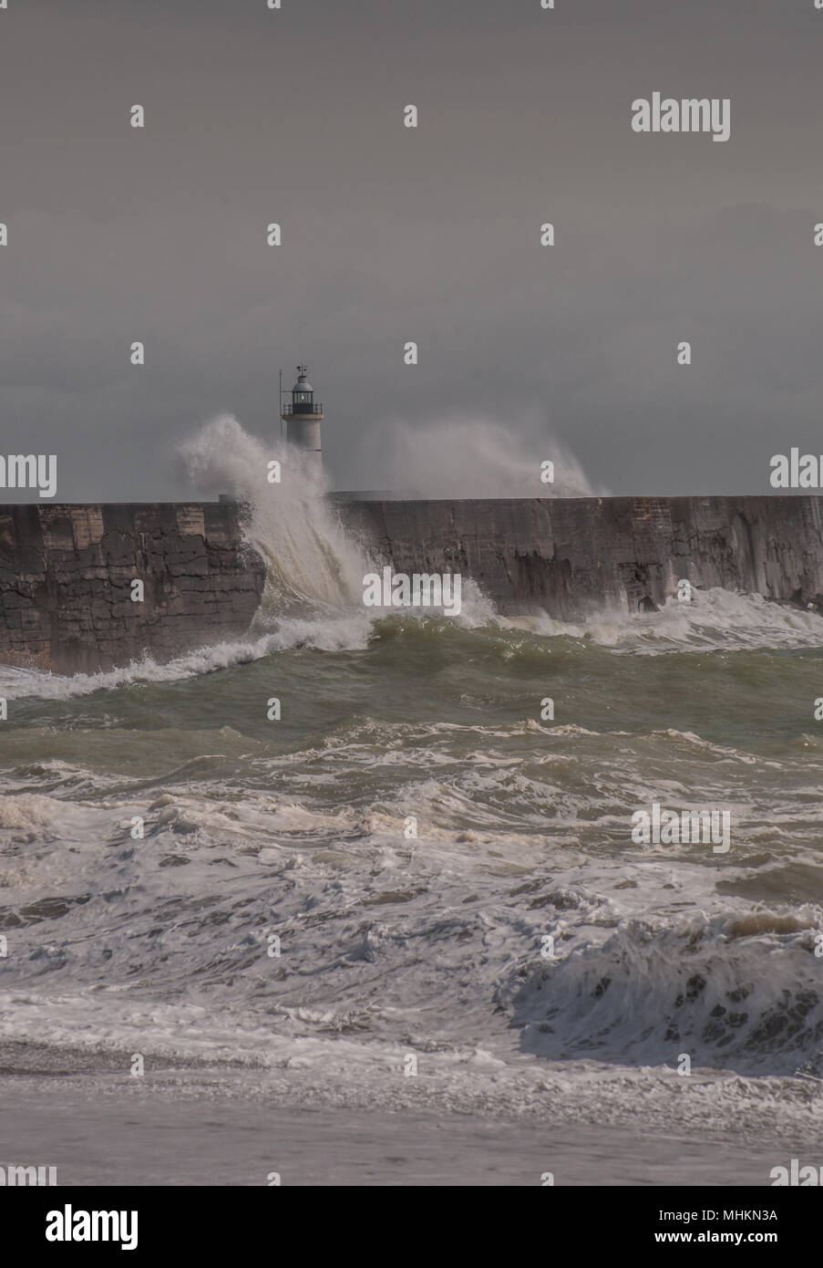 Newhaven, East Sussex, UK..2 May 2018. UK Weather:Brighter later in the day after dark clouds & rain, strong wind whips up the surf at the harbour West break water before finally abating.. Stock Photo