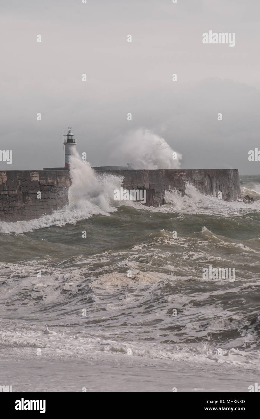 Newhaven, East Sussex, UK..2 May 2018. UK Weather:Brighter later in the day after dark clouds & rain, strong wind whips up the surf at the harbour West break water before finally abating.. Stock Photo