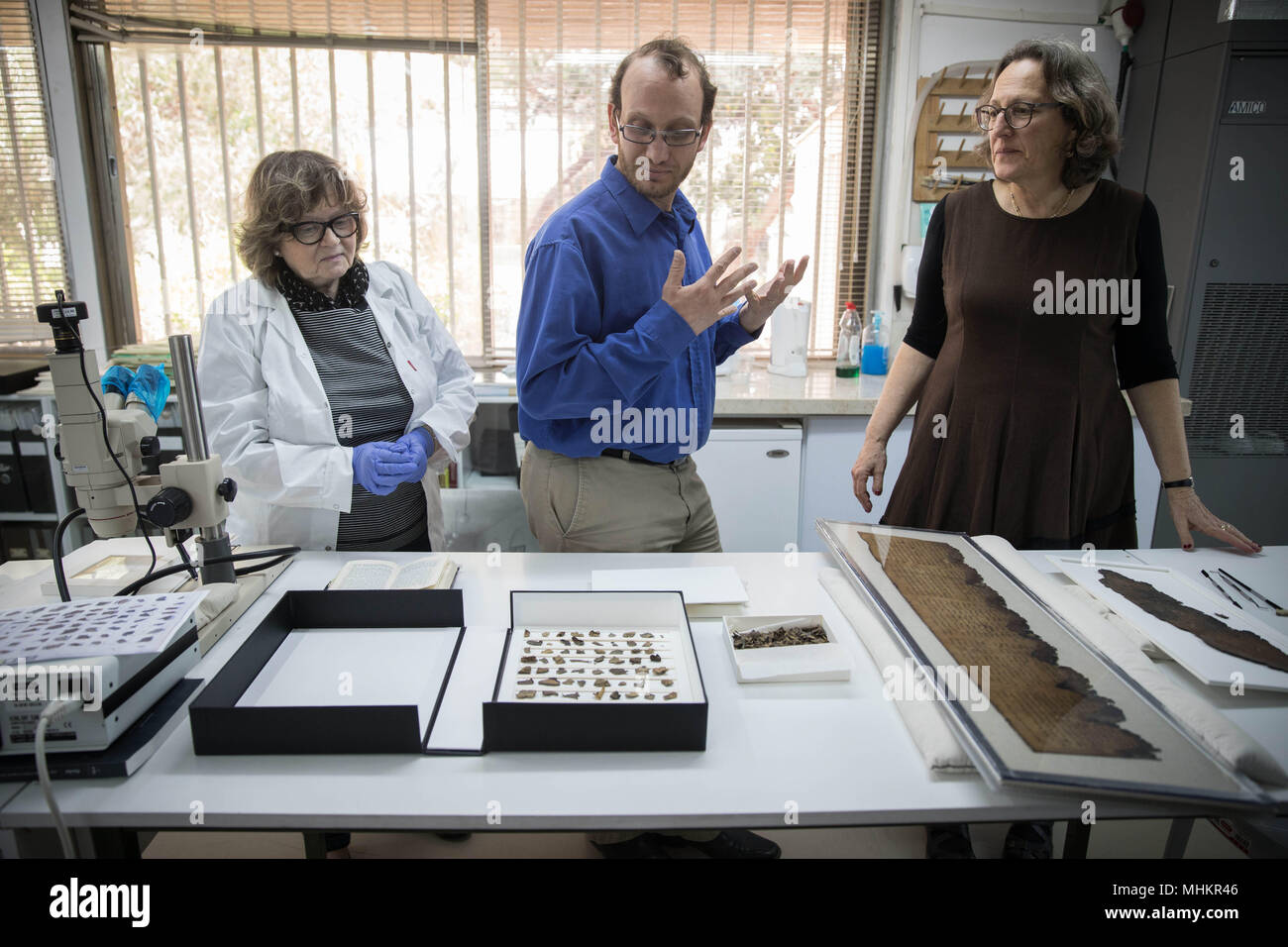 Jerusalem. 2nd May, 2018. Israel Antiquities Authority (IAA) staff members show fragments of a script at the IAA department in the Israel Museum in Jerusalem, on May 2, 2018. Advanced imaging technology originally developed for NASA has revealed previously unnoticed writing on fragments of the Dead Sea Scrolls, the IAA revealed on Tuesday. Moreover, one of the newly discerned and deciphered passages, written in early Hebrew, hints at the existence of a scroll never found and still unknown to researchers. Credit: JINI/Xinhua/Alamy Live News Stock Photo