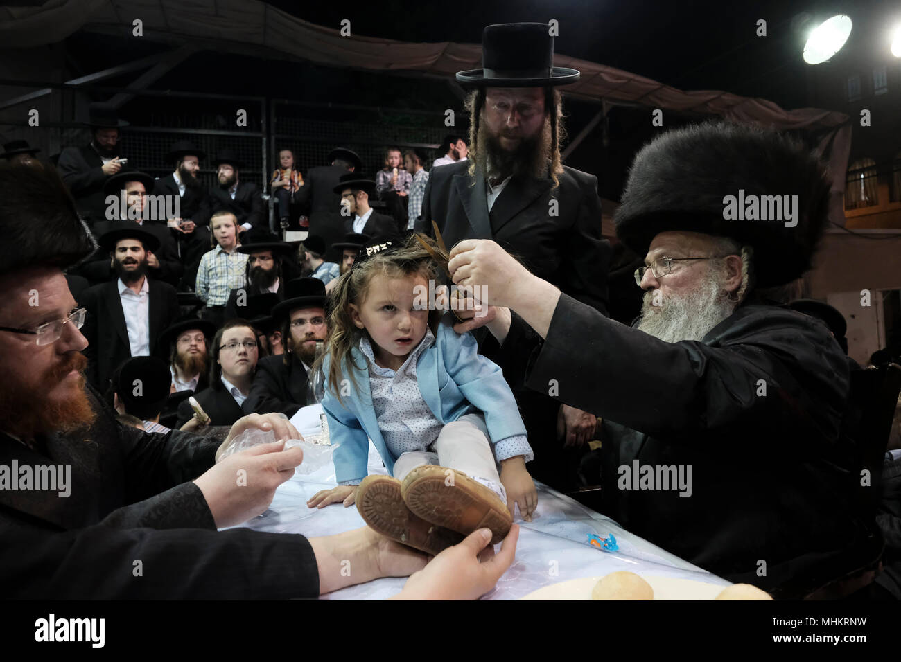 Jerusalem, Israel 02 May 2018. A three-year old Jewish boy takes part in the traditional Halake ceremony, a first hair cut from the Rabbi of the Pinsk-Karlin Hassidic dynasty in Geula religious neighborhood during the celebration of Lag BaOmer holiday which marks the celebration, interpreted by some as anniversary of death of Rabbi Shimon bar Yochai, one of Judaism's great sages some 1800 years ago and the day on which he revealed the deepest secrets of kabbalah a landmark text of Jewish mysticism Credit: Eddie Gerald/Alamy Live News Stock Photo