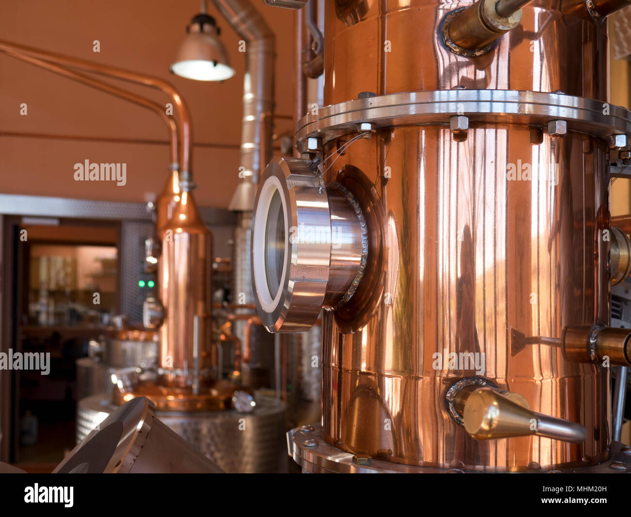 alembic still for making alcohol inside distillery, destilling spirits