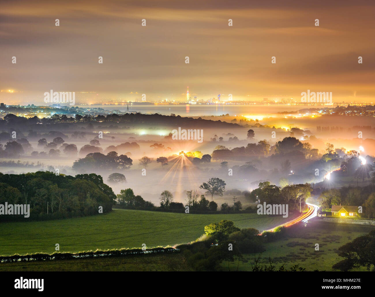 Mist and fog at night in a valley leading to the coast and the Solent Stock Photo