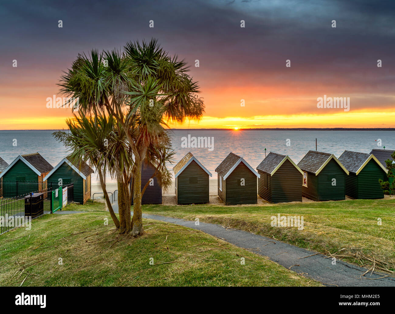 Tropical beach huts at sunset, Gurnard Isle of Wight Stock Photo