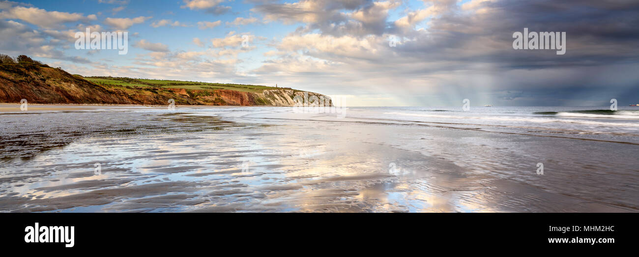 Panorama of beach and cliffs with sunbeams over the sea at Sandown Isle of Wight Stock Photo