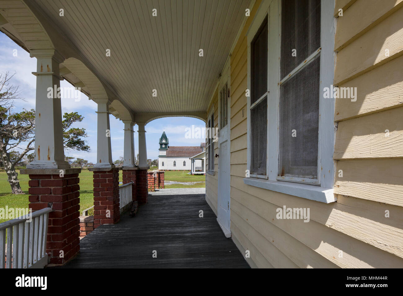 NC01597-00...NORTH CAROLINA - Front porch and church in the historical town of Portsmouth, Cape Lookout National seashore. Stock Photo