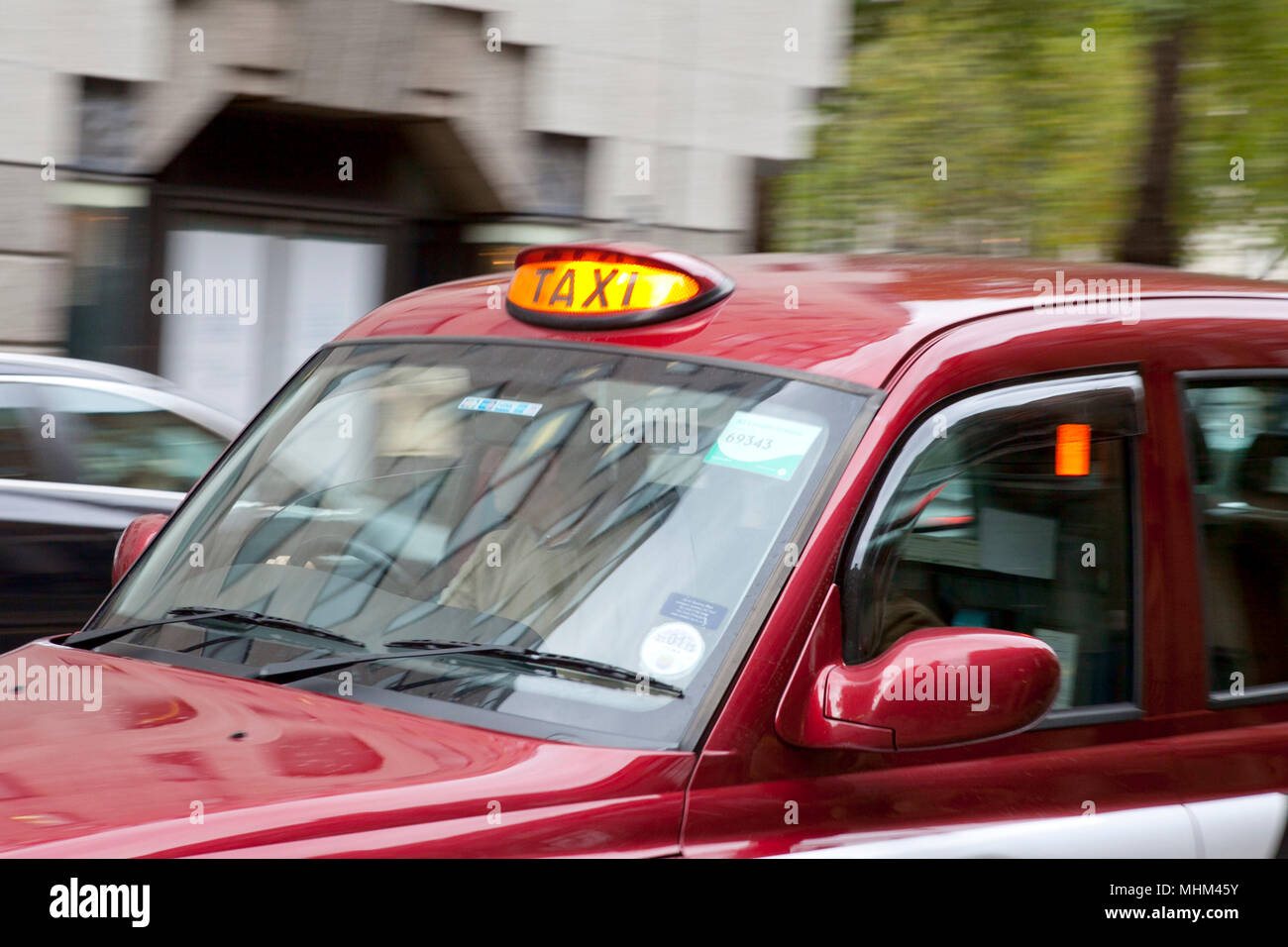 London taxi cab speeding through London with for hire light on with blurred back ground Stock Photo