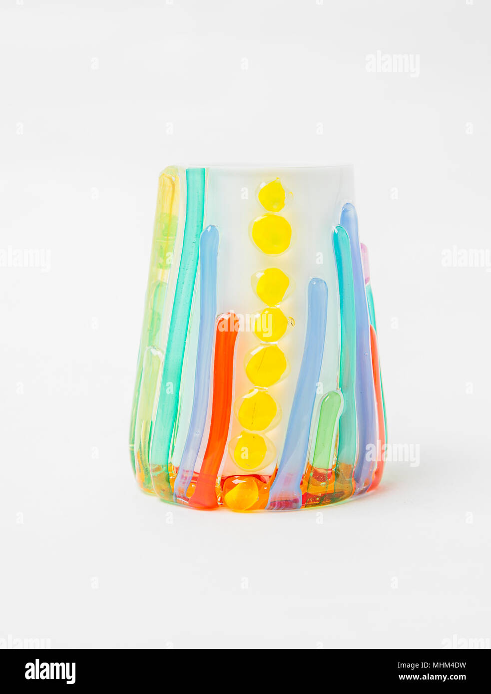 A colored scented candle holder in white background Stock Photo