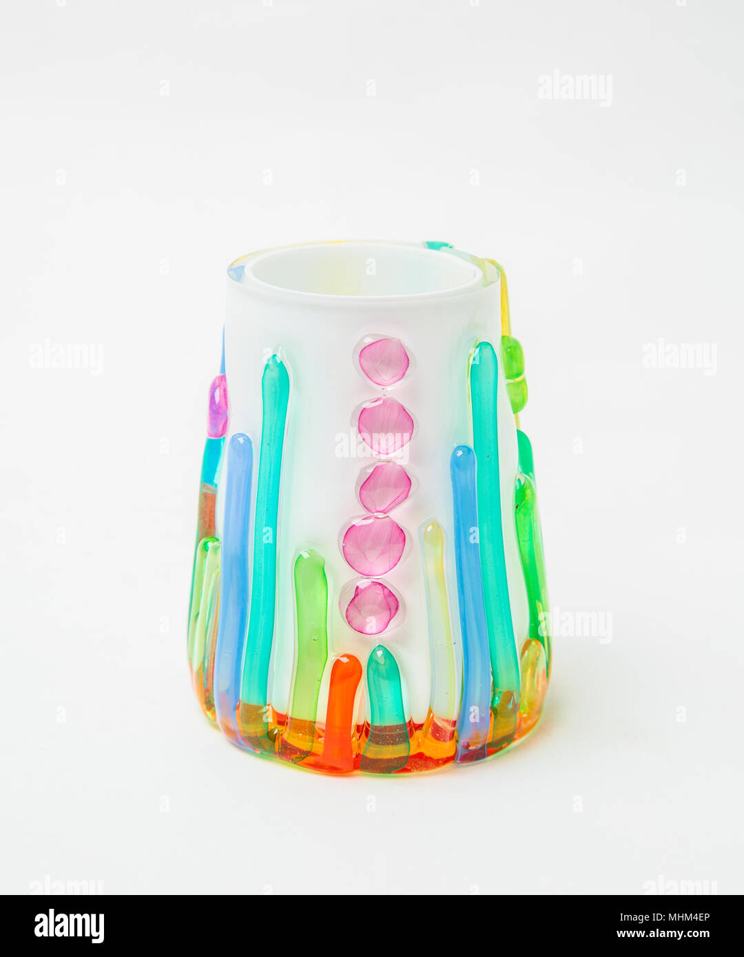 A colored scented candle holder in white background Stock Photo