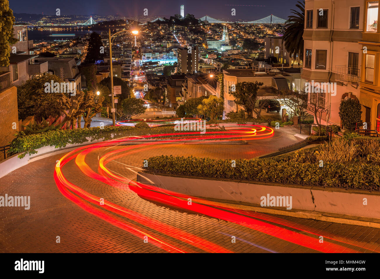 Crookedest Street at Night - Night panoramic view of Lombard Street, the steepest and crookedest street, and city neighborhoods, San Francisco, CA. Stock Photo