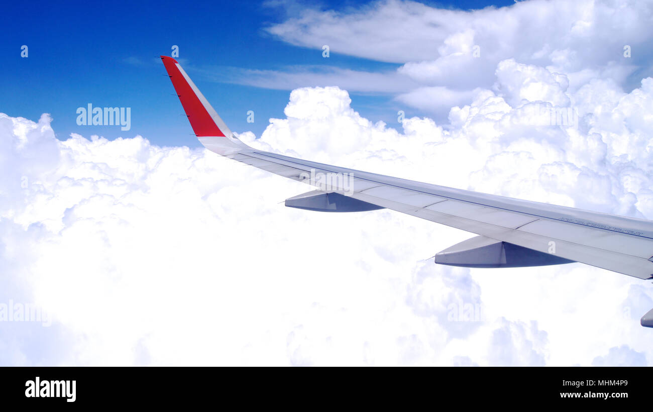 KUALA LUMPUR, MALAYSIA - APR 4th 2015: View of the clouds and airplane wing from inside an plane, window seat Stock Photo