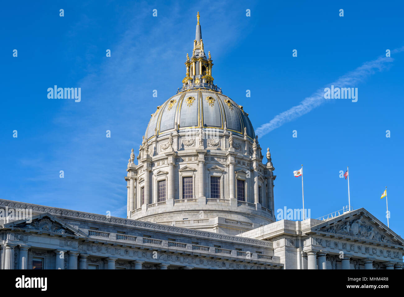 San Francisco City Hall - A close-up view of Golden Dome of City Hall Building, with City, State and USA flags flying at front. San Francisco, CA, USA Stock Photo