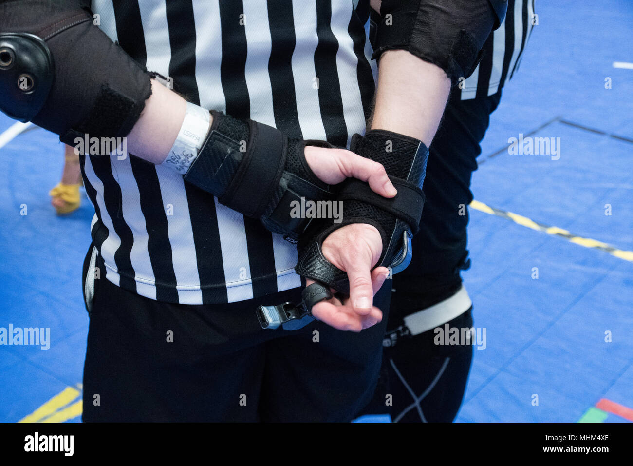 Detail of the hands and whistle of a roller derby referee Stock Photo