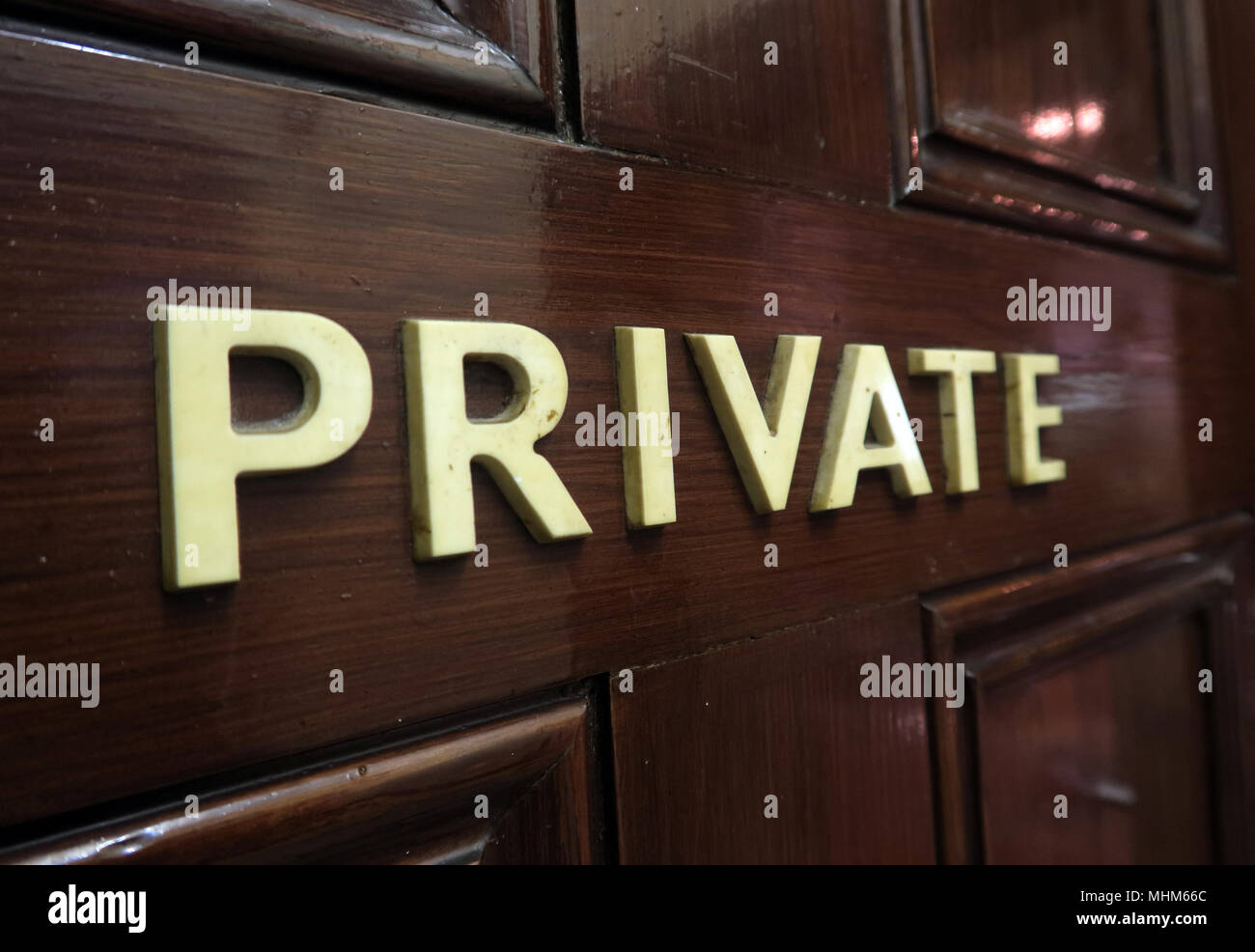 Private letters on a brown wooden door Stock Photo