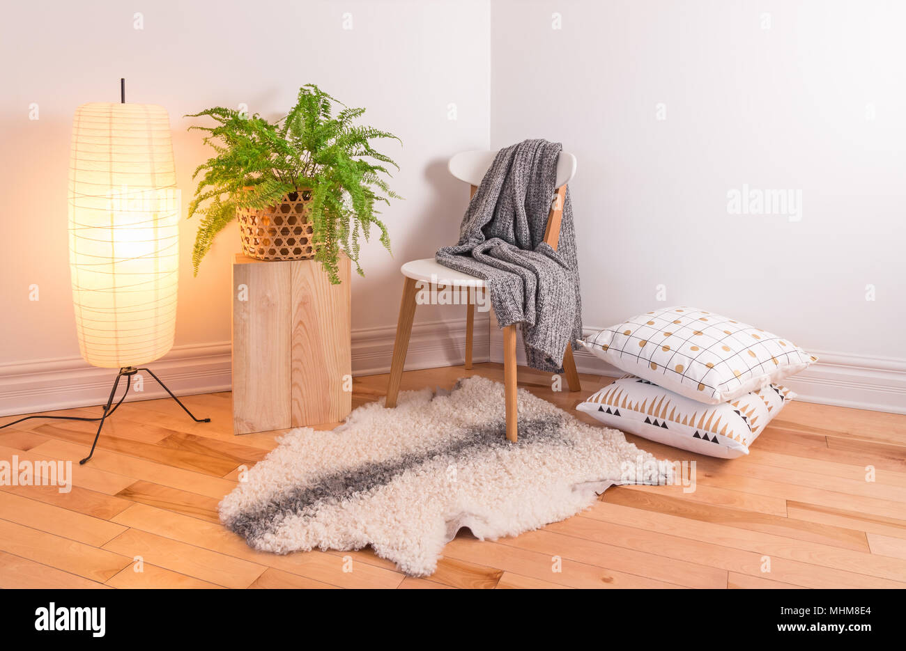 Room with cozy light decorated in Scandinavian style, using natural materials. Stock Photo