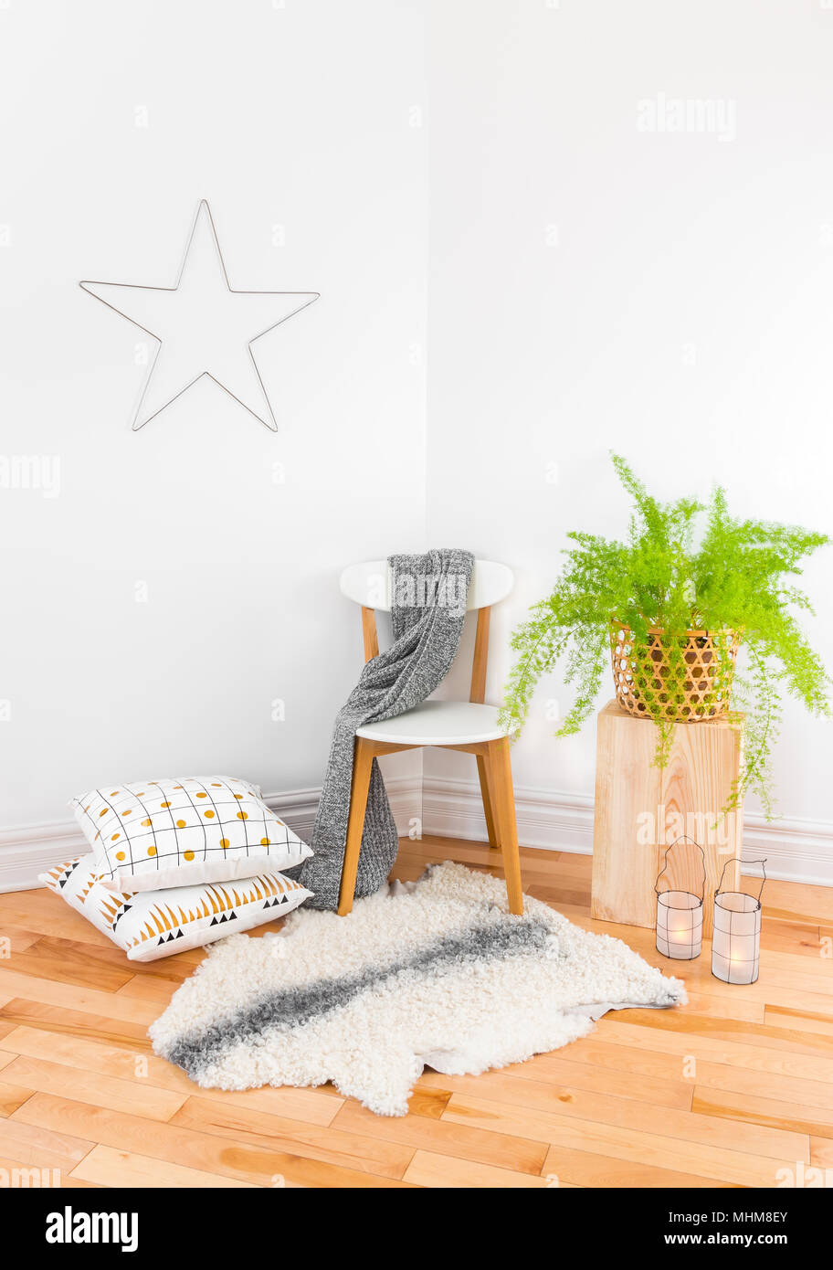 Beautiful home decor with cozy textiles and green plant, inspired by Scandinavian design. Stock Photo