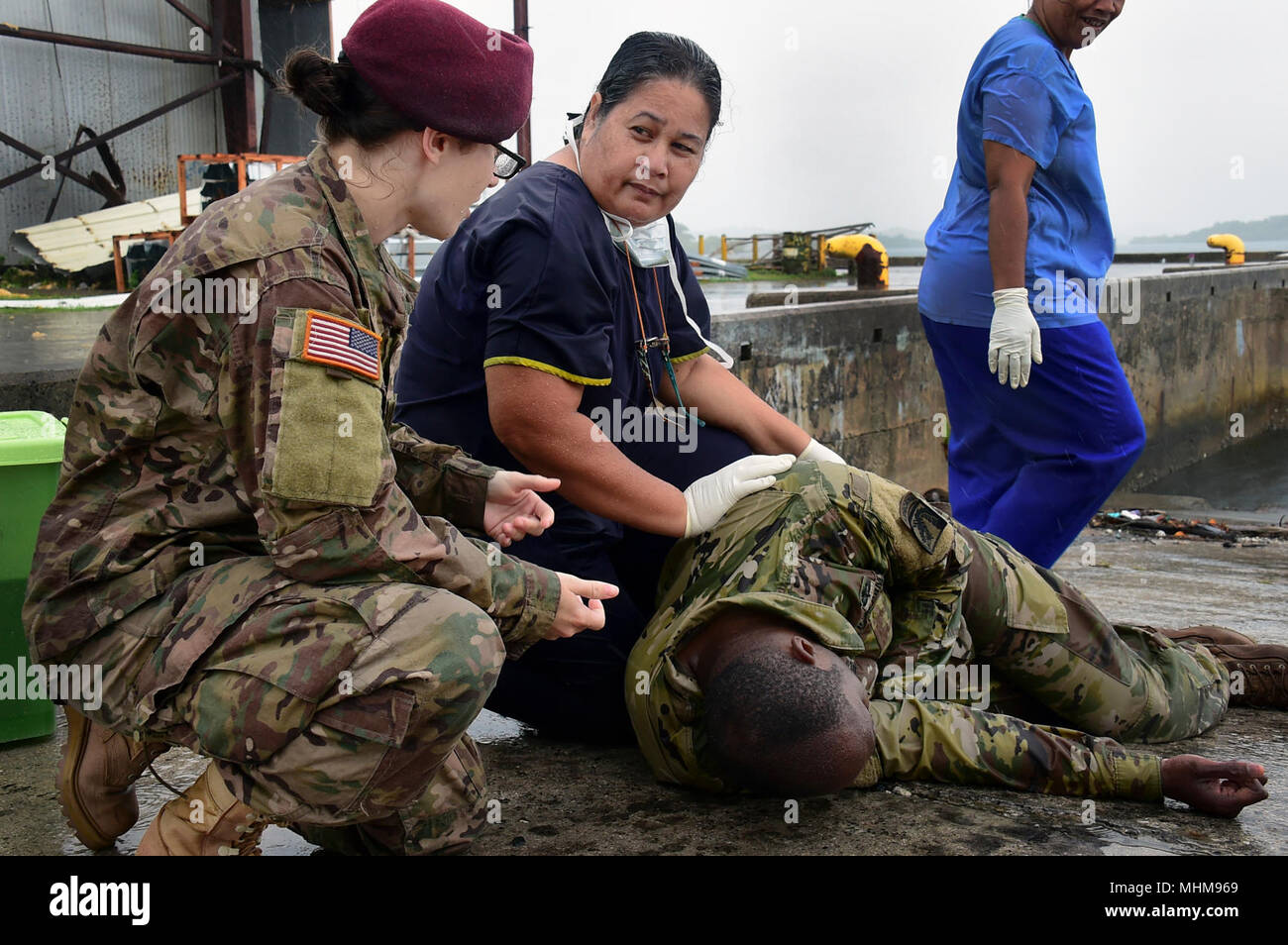 YAP, Federated States of Micronesia (March 28, 2018) U.S. Army Sgt. Alexa Falls (left) helps a local medical professional diagnose and treat U.S. Army Sgt. 1st Class Kevon Humphreys, a simulated medical casualty, while participating in a Humanitarian Assistance and Disaster Relief exercise during Pacific Partnership 2018 Yap (PP18) March 28. PP18's mission is to work collectively with host and partner nations to enhance regional interoperability and disaster response capabilities, increase stability and security in the region, and foster new and enduring friendships across the Indo-Pacific Reg Stock Photo