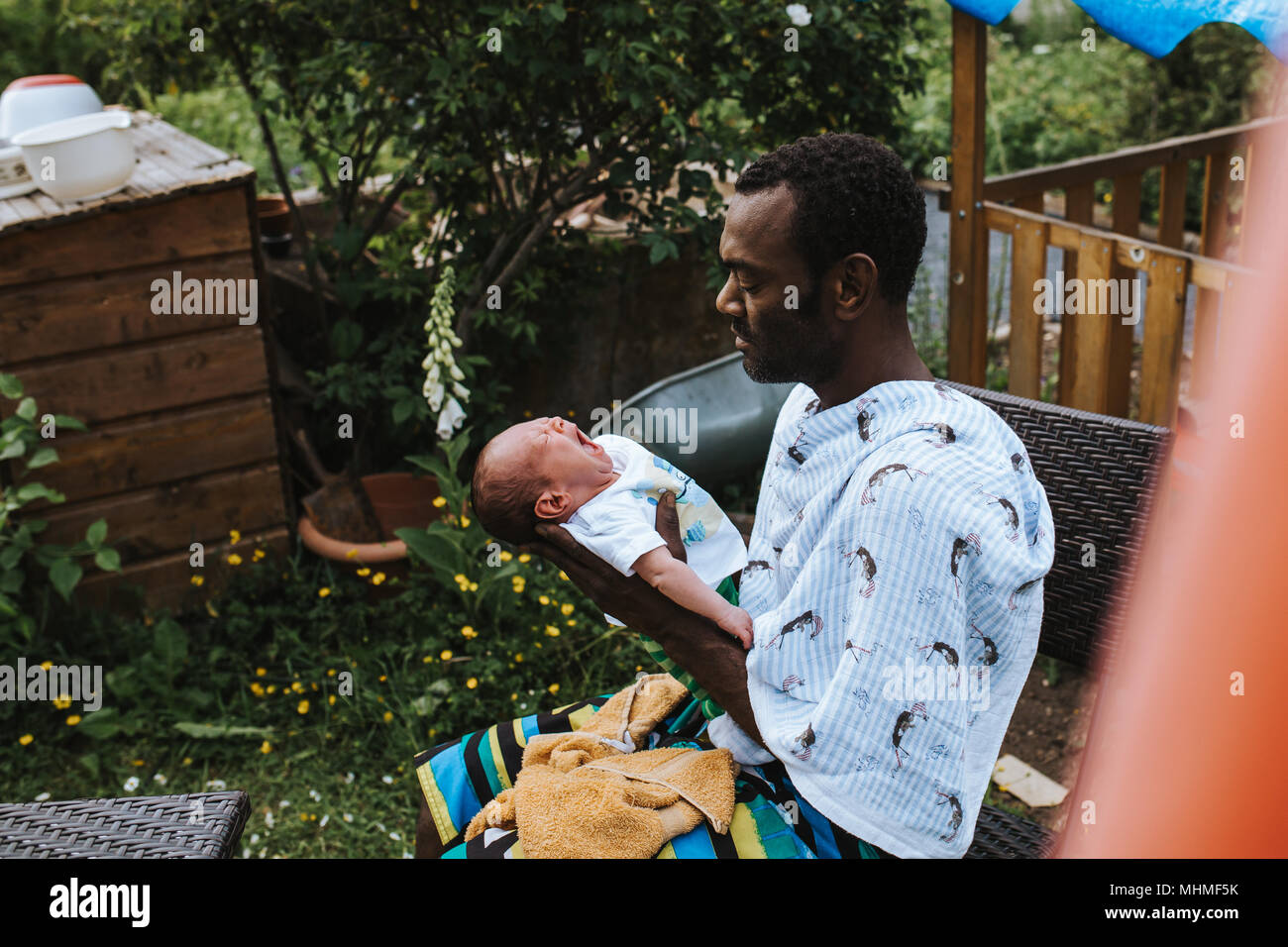 black father holding his mixed race baby boy Stock Photo - Alamy