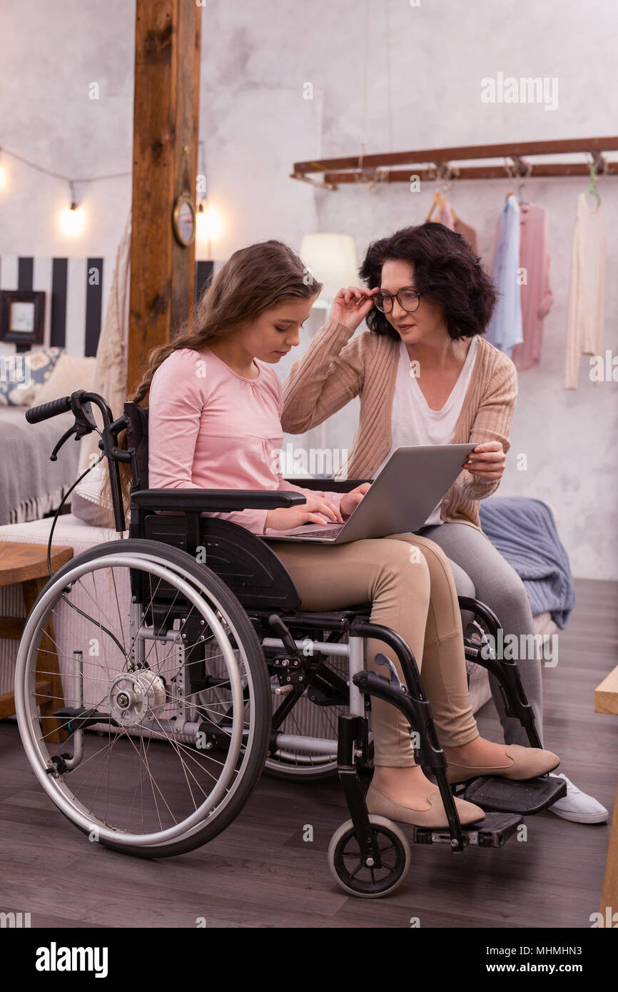 Focused handicapped girl using laptop Stock Photo
