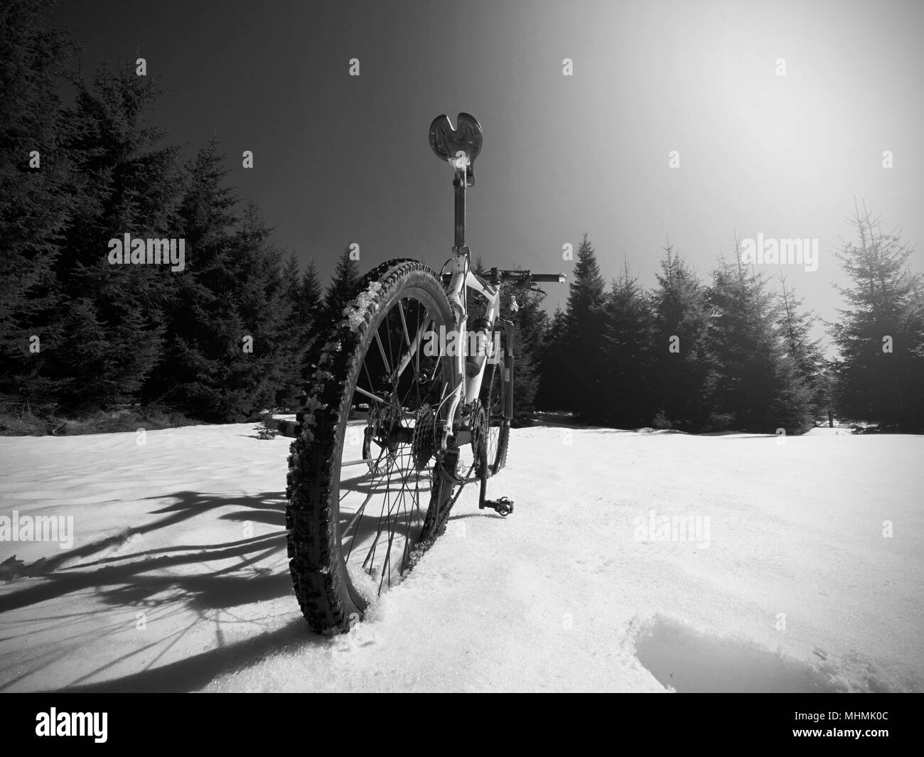 Cycling in winter snowy mountains on large tire wheels mountain bike