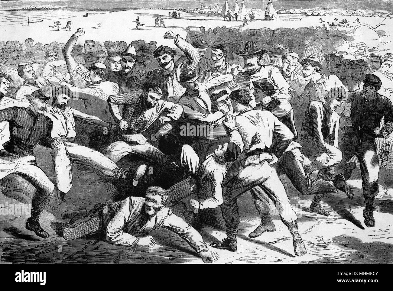 The rules of the game are overlooked by soldiers during a brutal game in camp, as fights break out everywhere and the ball is ignored.      Date: 1865 Stock Photo