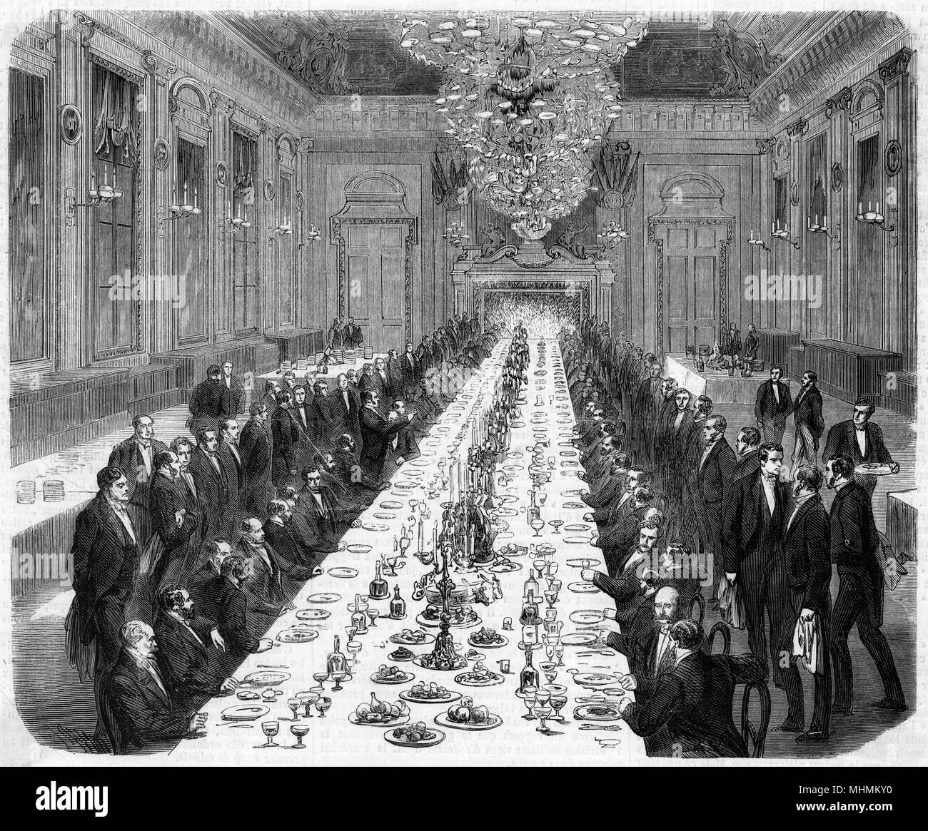 Every guest at this formal banquet has his own servant to attend to him.       Date: 1861 Stock Photo