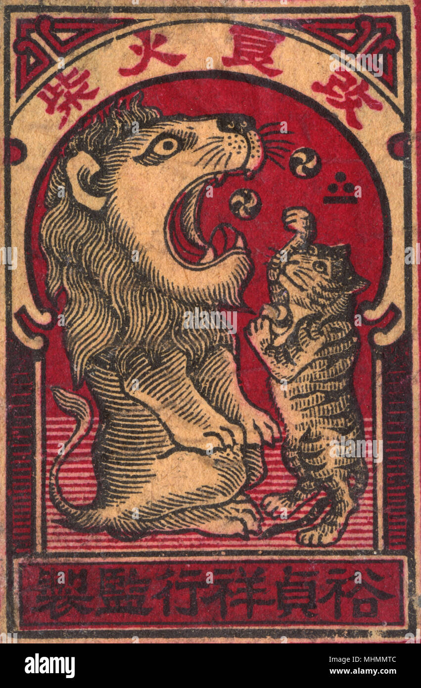 Old Japanese Matchbox label of a cat playing with a lion Stock Photo