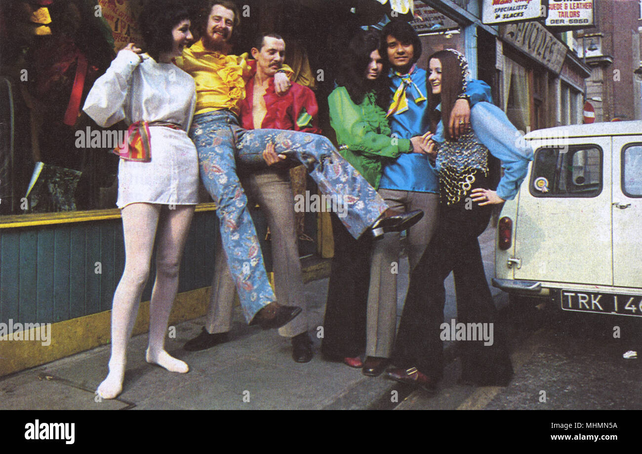 A group of groovy people wearing flamboyant fashions of the 1960s in Carnaby Street, London.       Date: 1966 Stock Photo