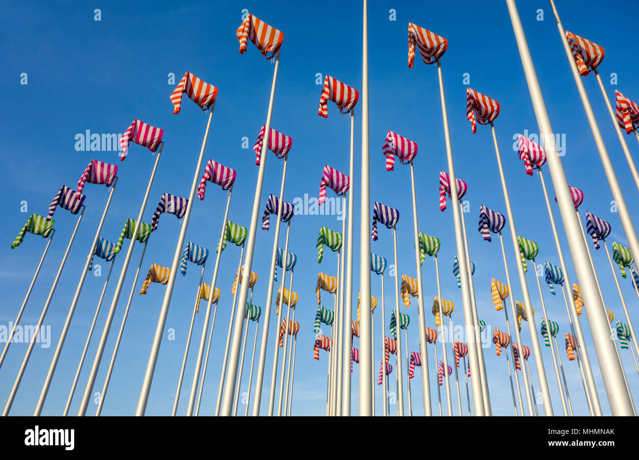 Artwork Le vent souffle où il veut by artist Daniel Buren, hundred flag poles with colorful windsocks at Nieuwpoort / Nieuport, West Flanders, Belgium Stock Photo