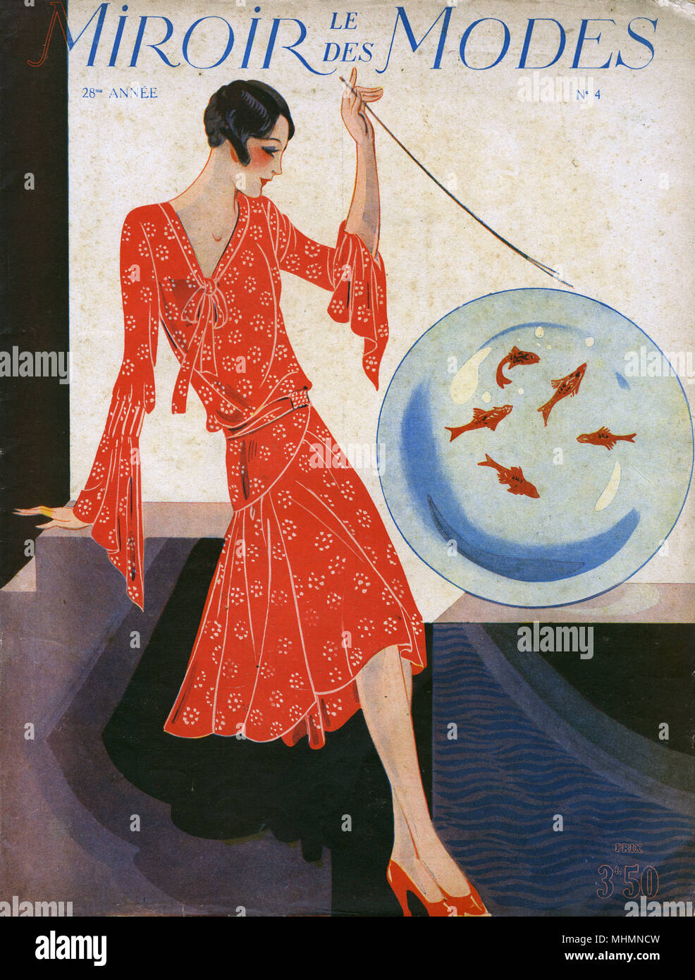 Front cover of French fashion magazine, Le Miroir des Modes featuring a woman in a draped red patterned day dress alongside a glass sphere or bowl of goldfish.      Date: c.1920 Stock Photo