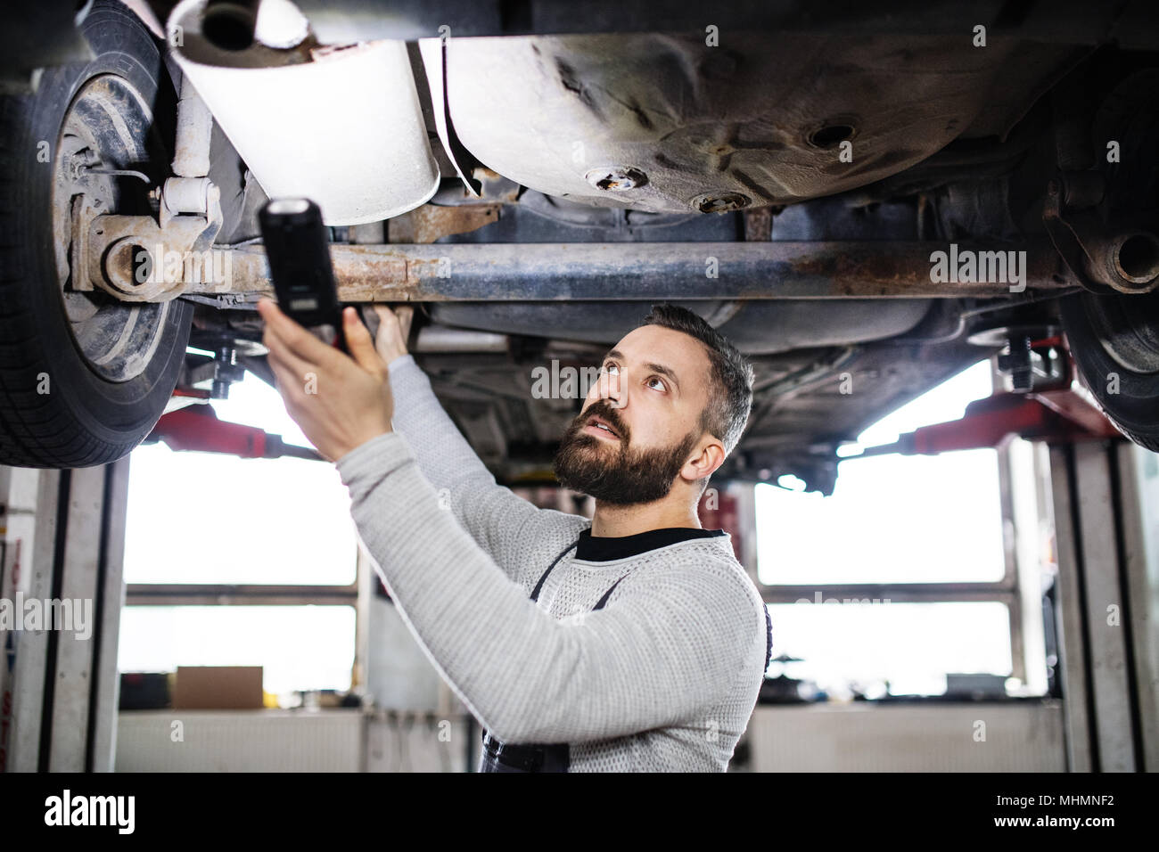 Man Mechanic Repairing A Car In A Garage Stock Photo 183008758