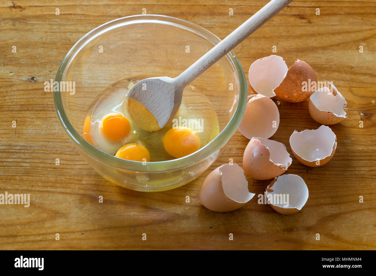 Egg yolks in bowl to be beaten for omelette and scrambled eggs Stock Photo