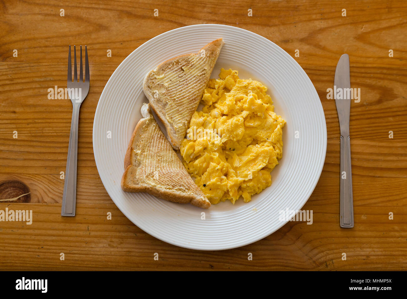 Plate with scrambled egg and bacon on white background Stock Photo - Alamy