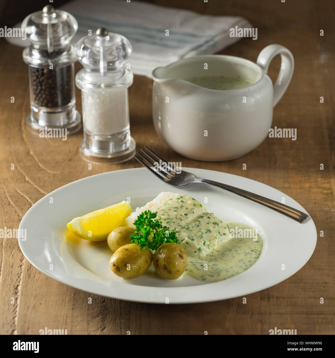 Cod in parsley sauce. Stock Photo