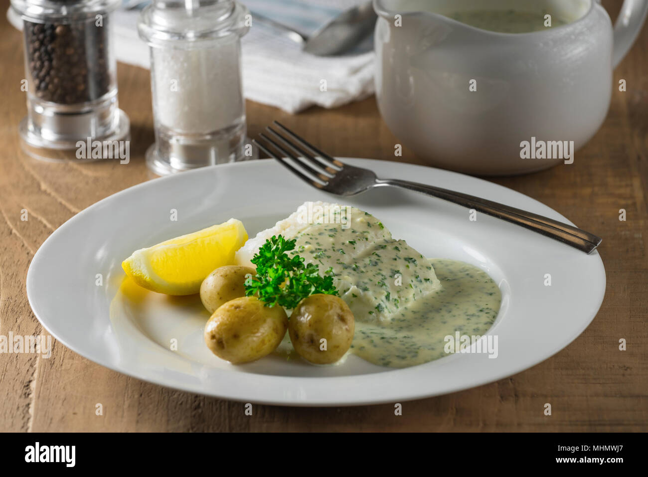 Cod in parsley sauce. Stock Photo