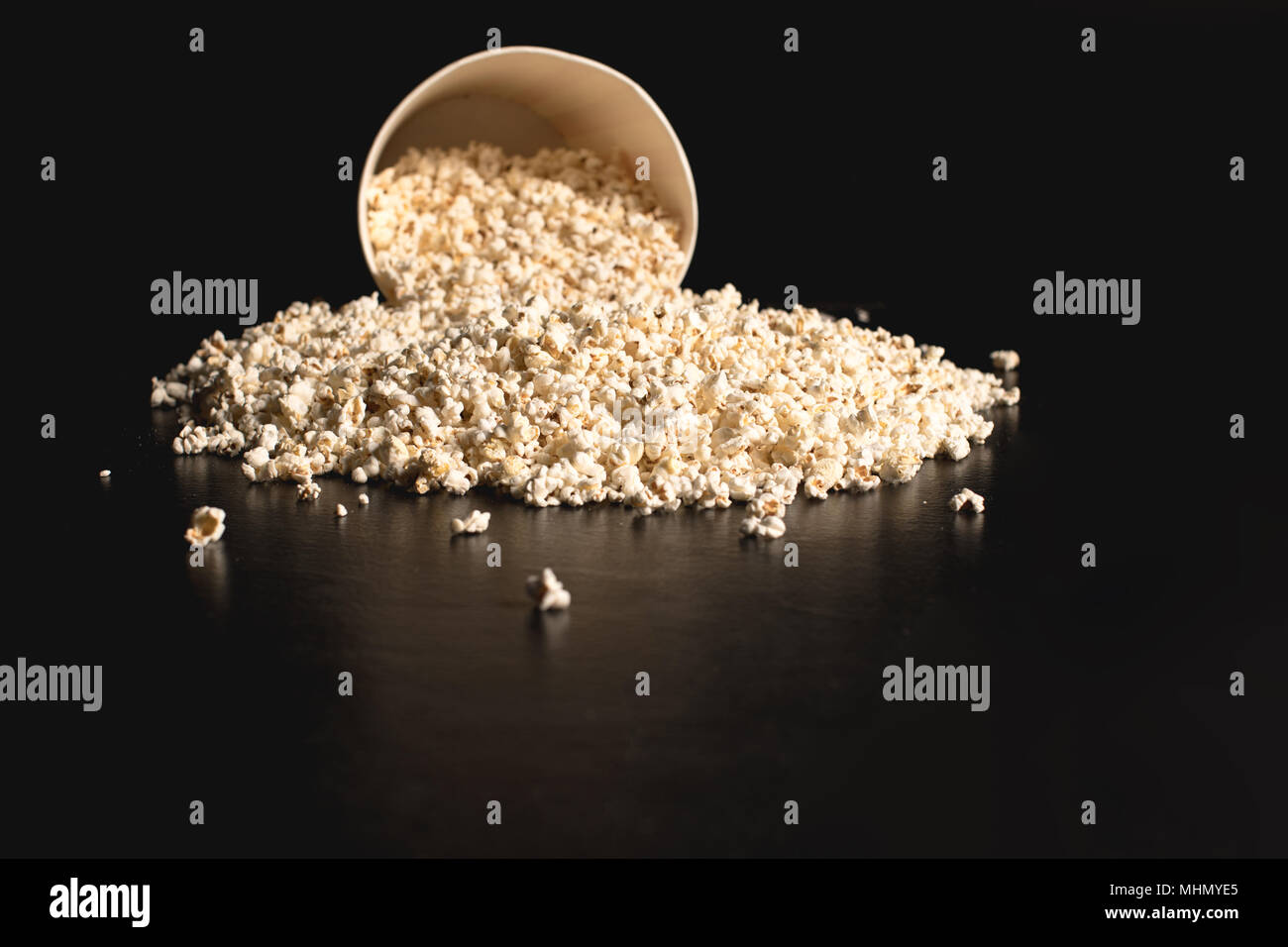popcorn spilled from cardboard bucket Stock Photo Alamy