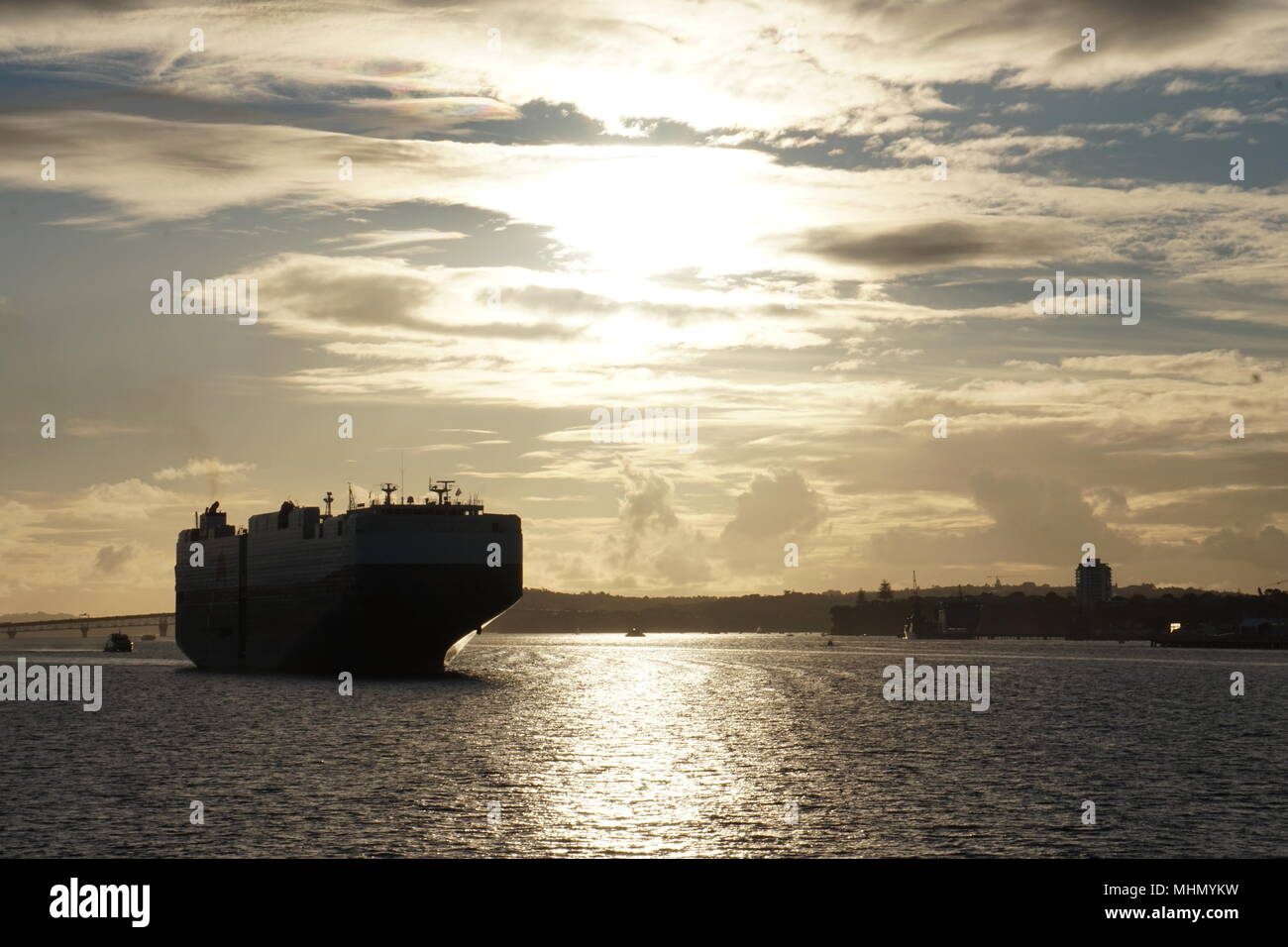 ship prow bow silhouette at sunset Auckland harbor operation Stock Photo