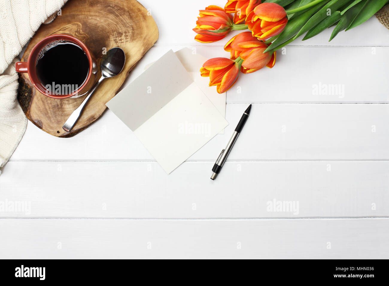 Overhead Shot A Bouquet Of Orange And Yellow Tulip Flowers With Black Coffee Empty Card With Copy Space And A Cozy Knit Throw Blanket Over White Woo Stock Photo Alamy