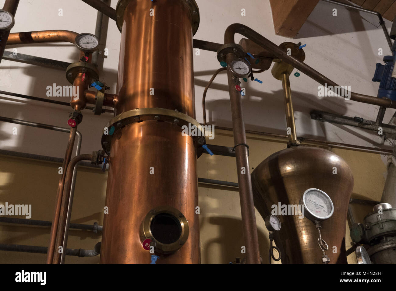 Copper still alembic inside distillery to distill grapes and produce