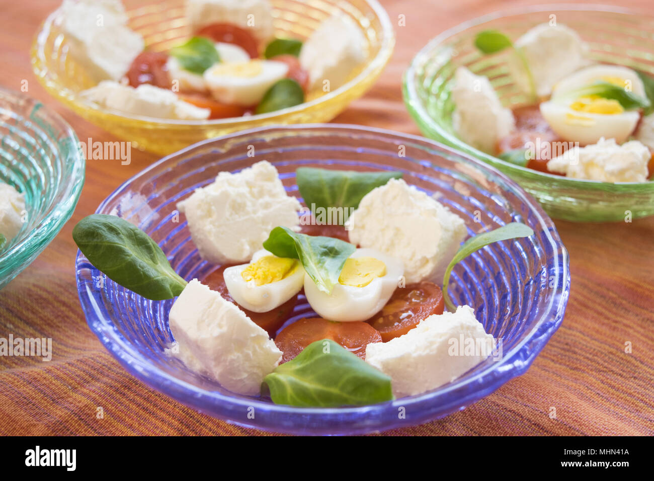 mixed appetiser with spreadable cheese, hard boiled eggs and cherry