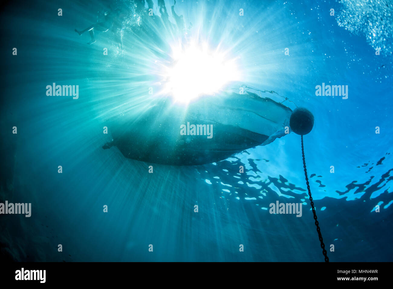 boat chain anchor from underwater with sun rays Stock Photo - Alamy