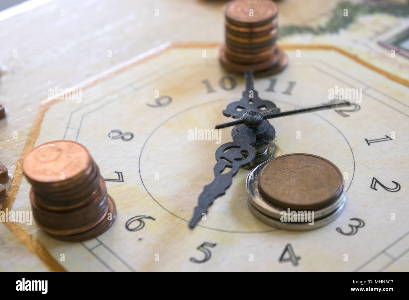 concept of time in business with a clock and some money Stock Photo