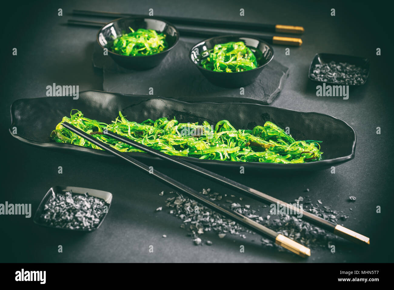 Japanese seaweed salad in a bowl on black background Stock Photo