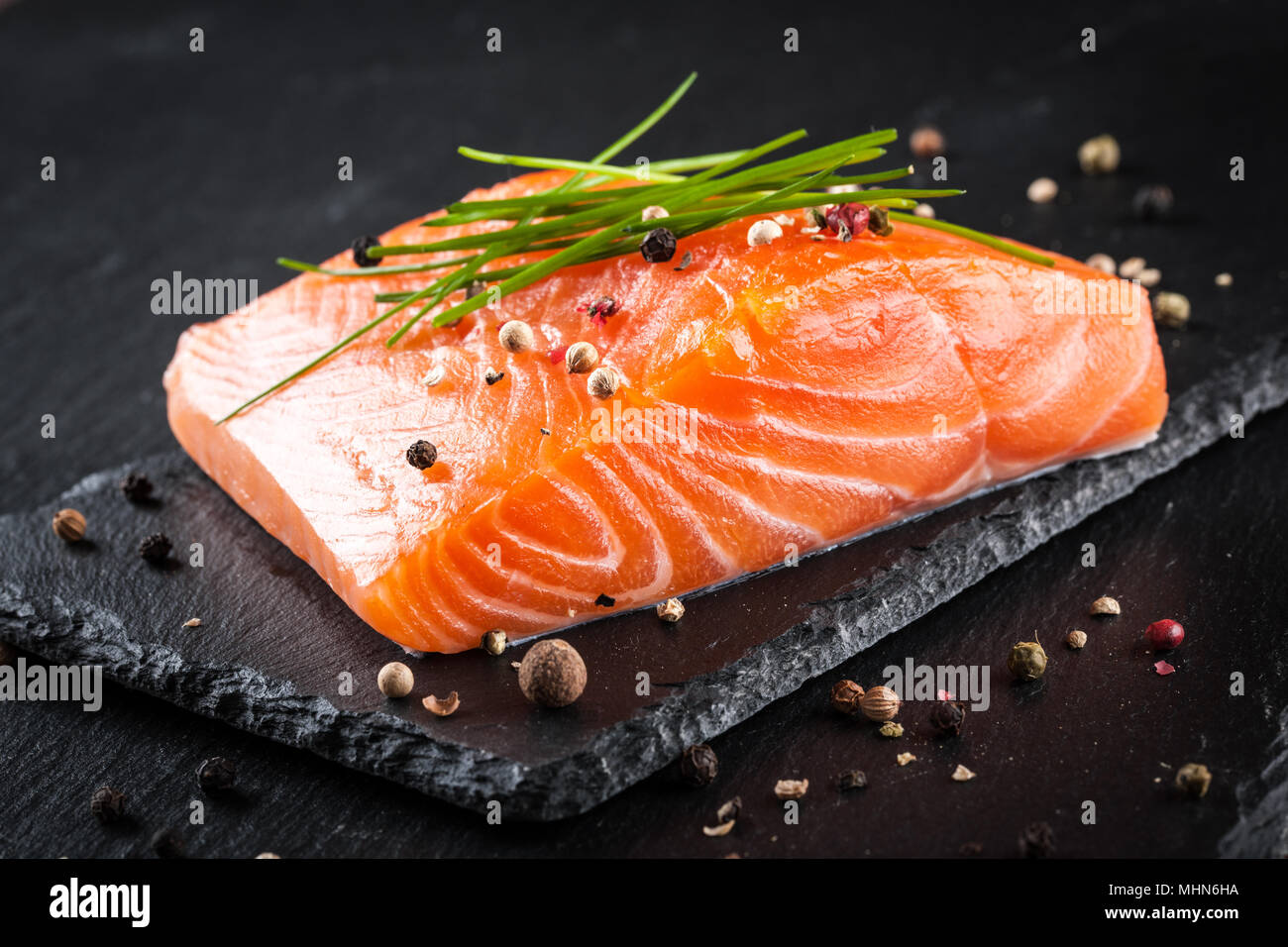 Fresh raw salmon fillet on the black cutting board Stock Photo - Alamy