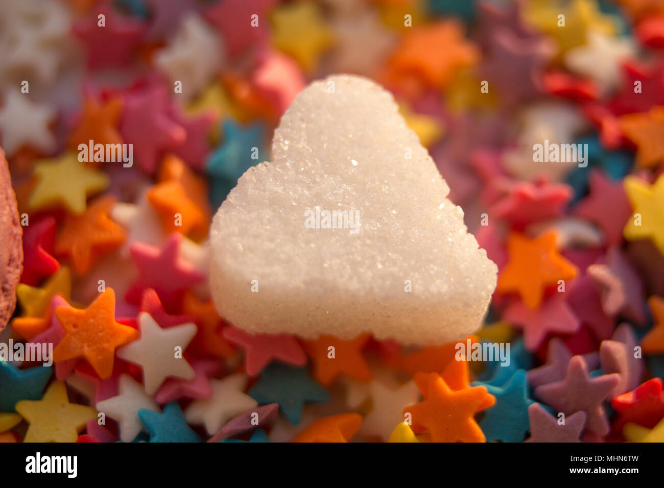 colorful sugar stars coating with white shugar heart on it Stock Photo